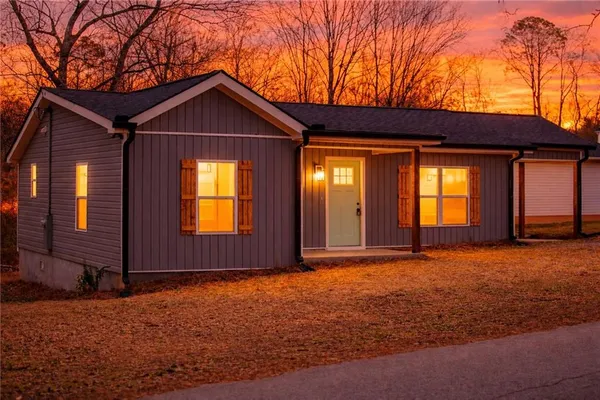 a view of an house with backyard space and garden