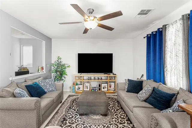 a living room with furniture and kitchen view