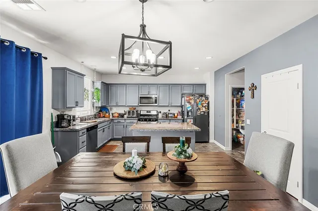 a kitchen with stainless steel appliances granite countertop a refrigerator stove microwave and sink