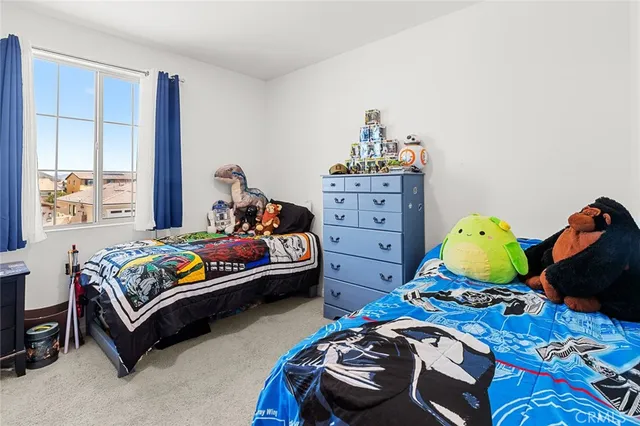 a bedroom with a bed furniture and a chandelier
