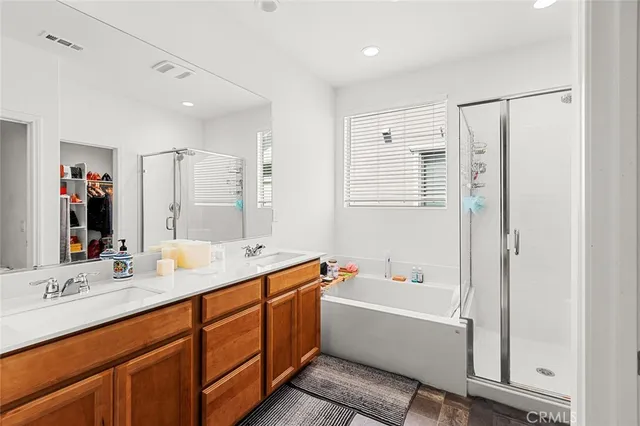 a bathroom with a granite countertop sink a mirror and a bathtub