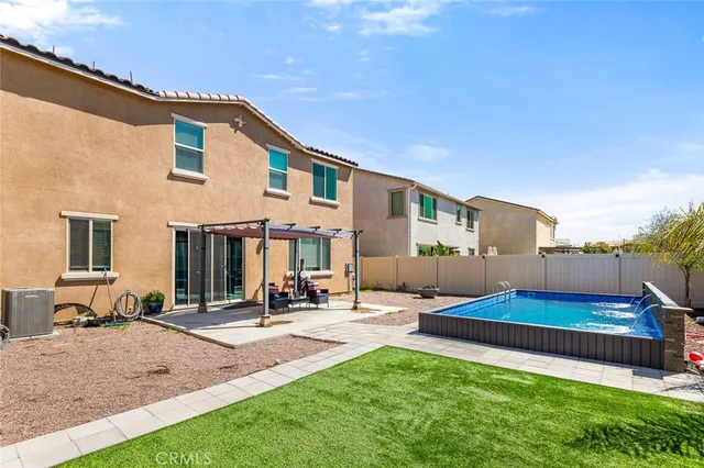 a swimming pool with an outdoor seating and yard