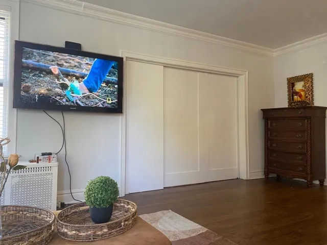 a living room with furniture and painting on the wall