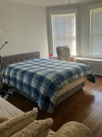 a bedroom with a bed and window