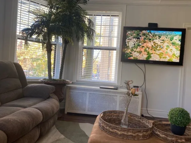 a living room with furniture and a large window