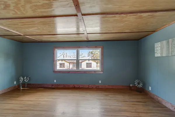 a view of a livingroom with furniture wooden floor and window