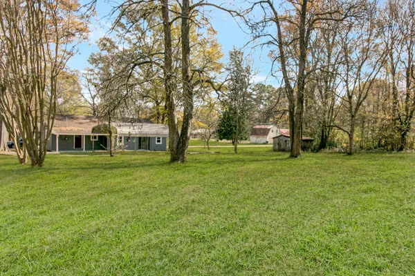 a view of a house with a backyard