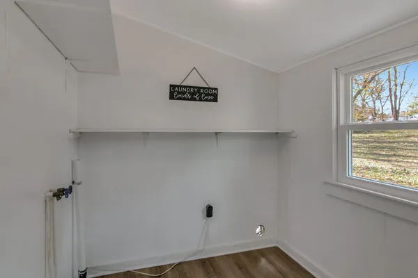 a view of a house with a big yard and large tree