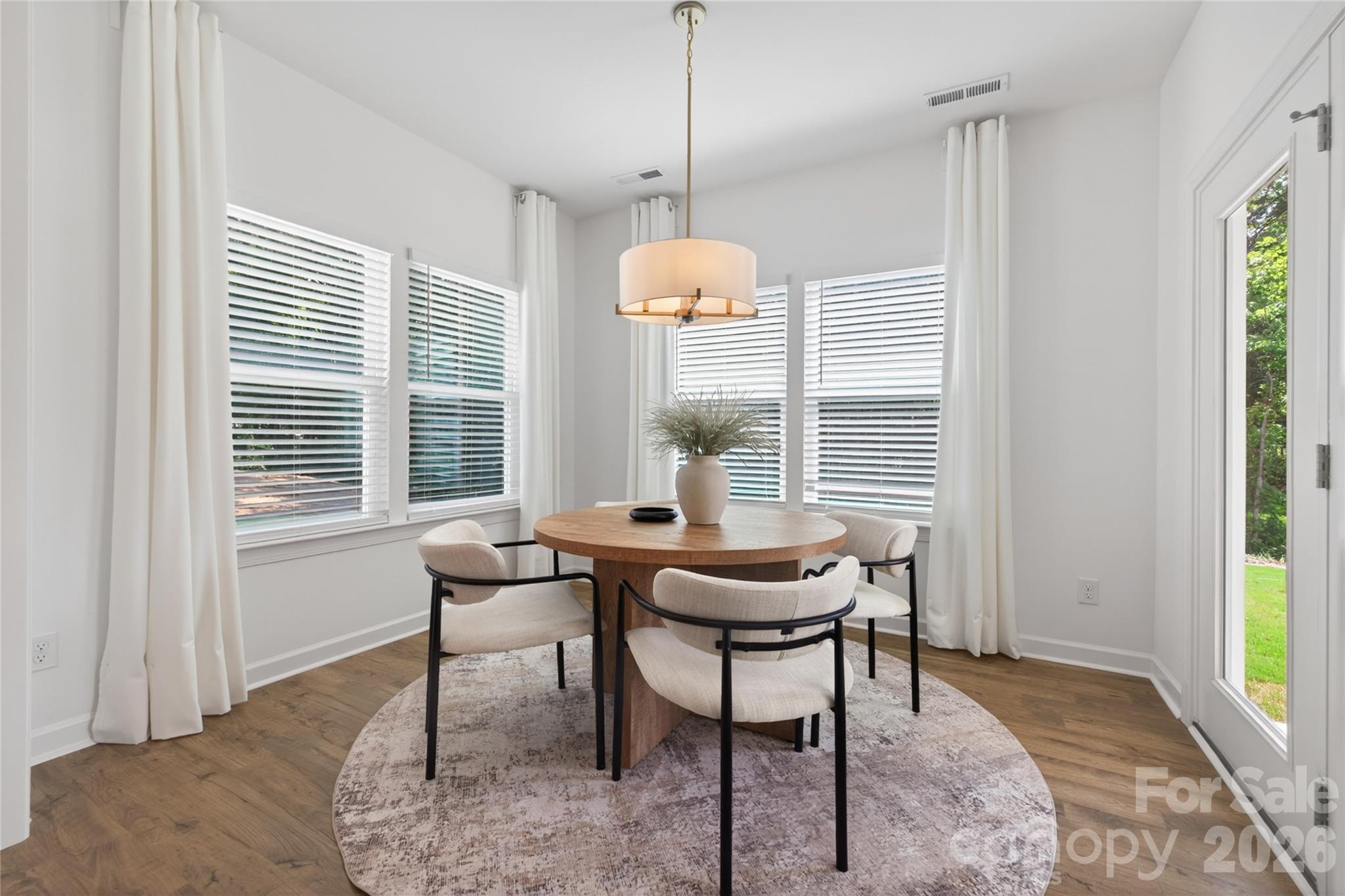 128 Overcash Road, Unit 7171 Troutman, NC 28166 - Photo 8 of 41 a dining room with furniture and windows