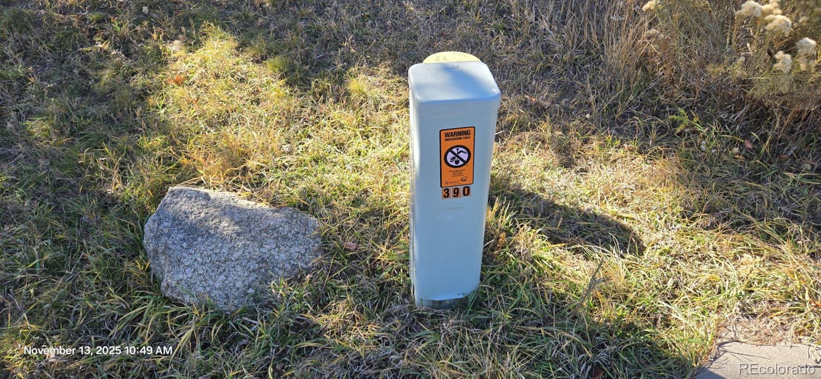 390 Irvington Court Colorado Springs, CO 80906 - Photo 6 of 6 a sign board with a house and trees in the background