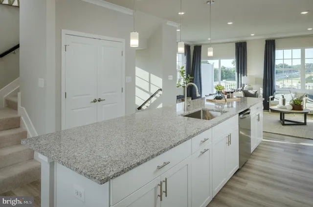 a large kitchen with kitchen island a sink appliances and a counter space