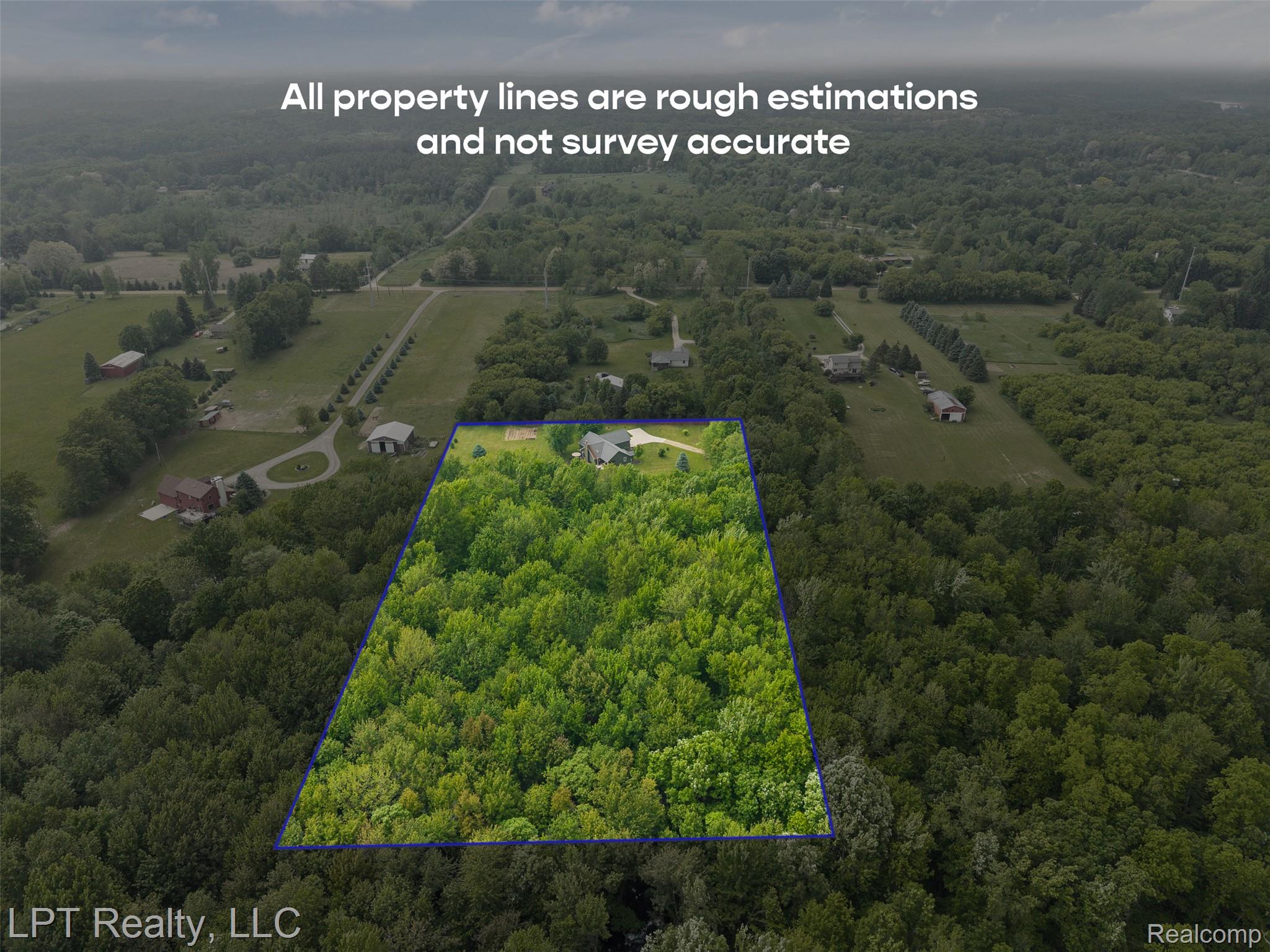2588 East Jones Road Howell, MI 48855 - Photo 2 of 40 Overview of rural landscape featuring a heavily wooded area and property parcel outlined