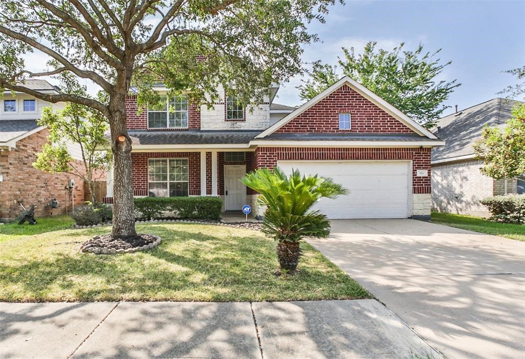 911 Merlin Roost Katy, TX 77494 - Photo 1 of 42 a front view of a house with a yard and potted plants