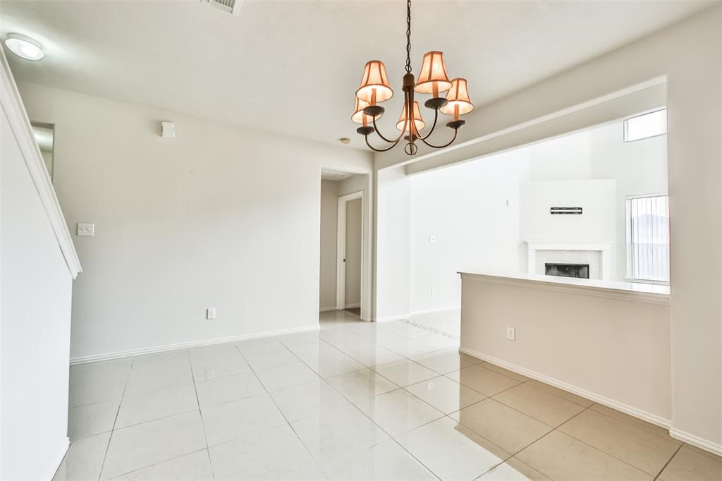 911 Merlin Roost Katy, TX 77494 - Photo 20 of 42 a view of a kitchen with a sink and chandelier