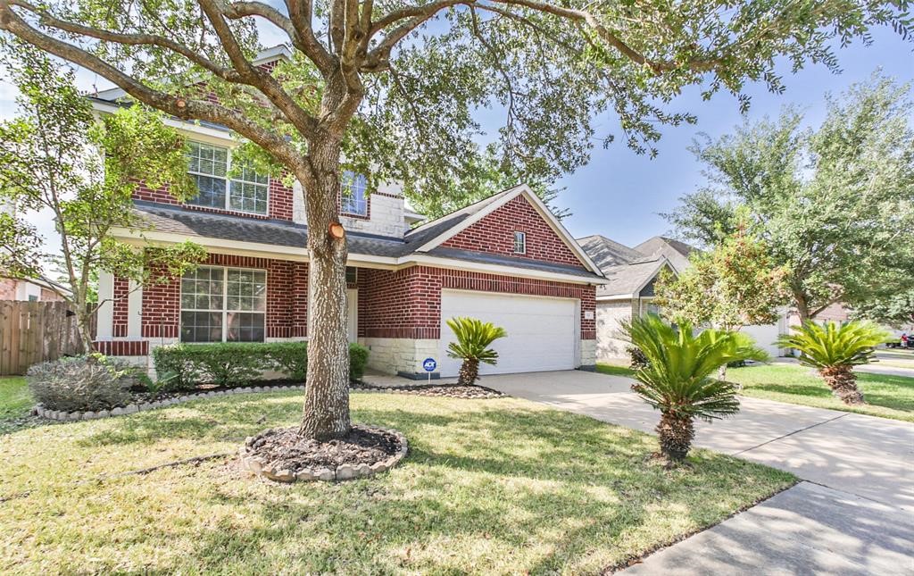 911 Merlin Roost Katy, TX 77494 - Photo 2 of 42 a front view of a house with garden