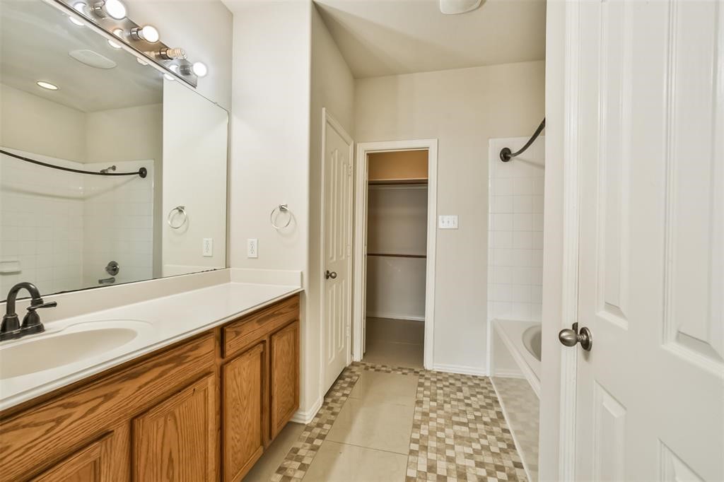 911 Merlin Roost Katy, TX 77494 - Photo 27 of 42 a bathroom with a sink and a mirror