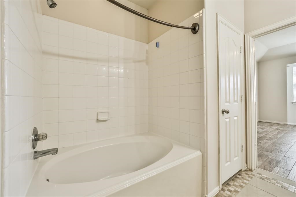 911 Merlin Roost Katy, TX 77494 - Photo 28 of 42 a bathroom with a bathtub
