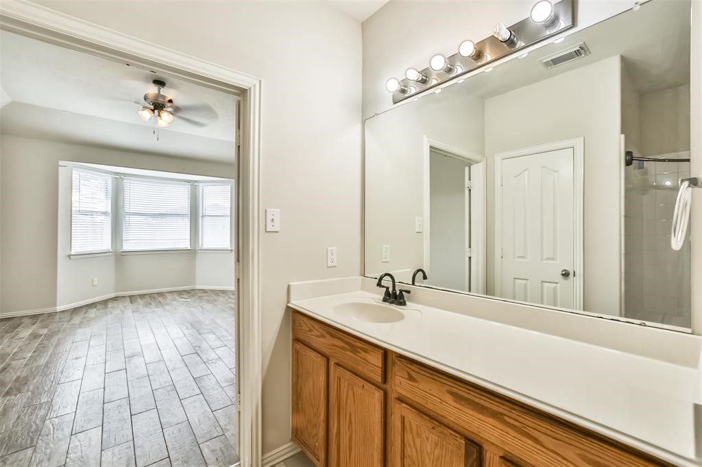 911 Merlin Roost Katy, TX 77494 - Photo 29 of 42 a bathroom with a sink and a mirror