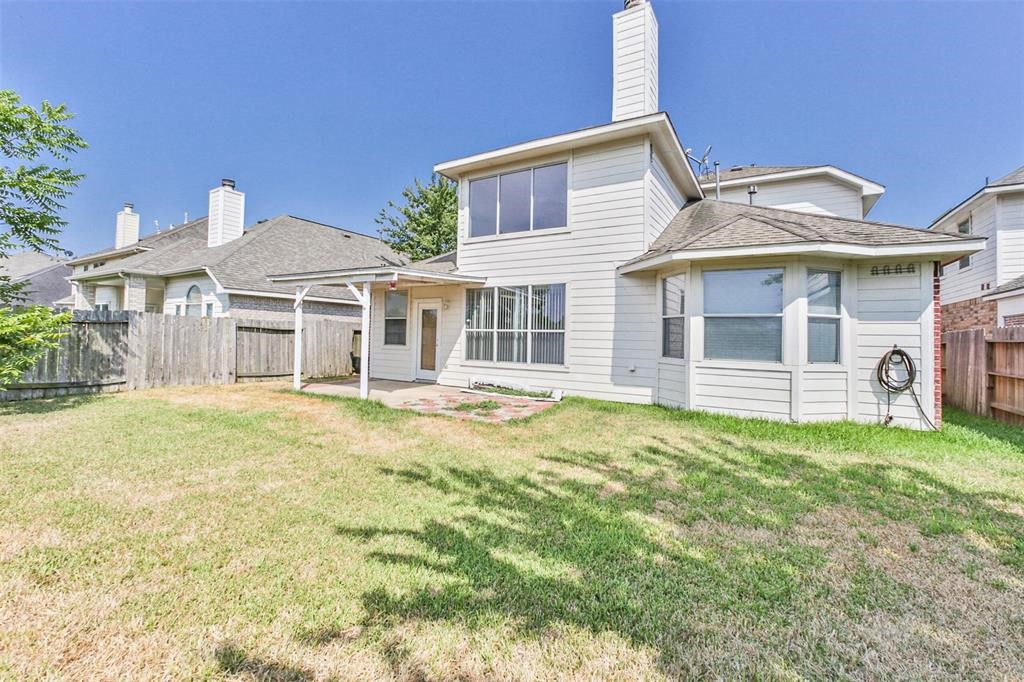 911 Merlin Roost Katy, TX 77494 - Photo 35 of 42 a front view of a house with a garden