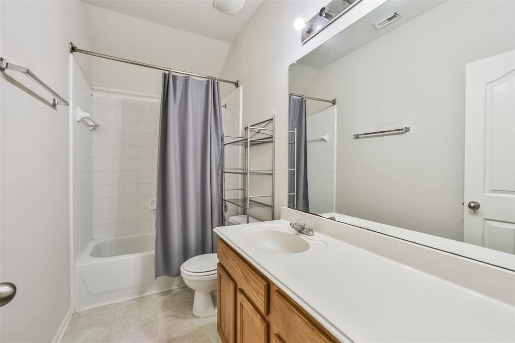 911 Merlin Roost Katy, TX 77494 - Photo 37 of 42 a bathroom with a granite countertop sink toilet and shower
