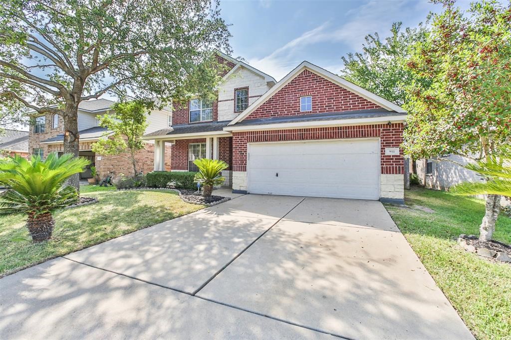 911 Merlin Roost Katy, TX 77494 - Photo 4 of 42 a front view of house with yard