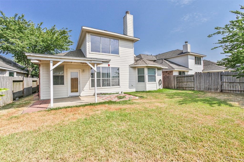 911 Merlin Roost Katy, TX 77494 - Photo 41 of 42 a front view of a house with a garden
