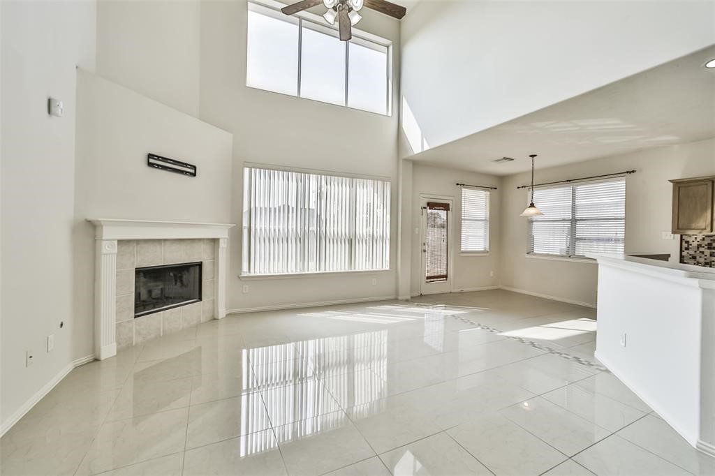 911 Merlin Roost Katy, TX 77494 - Photo 7 of 42 a view of an empty room with a fireplace and a window