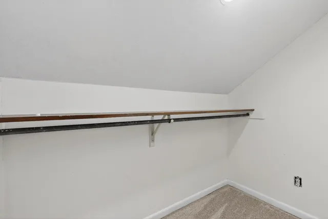 an empty room with a window and ceiling fan