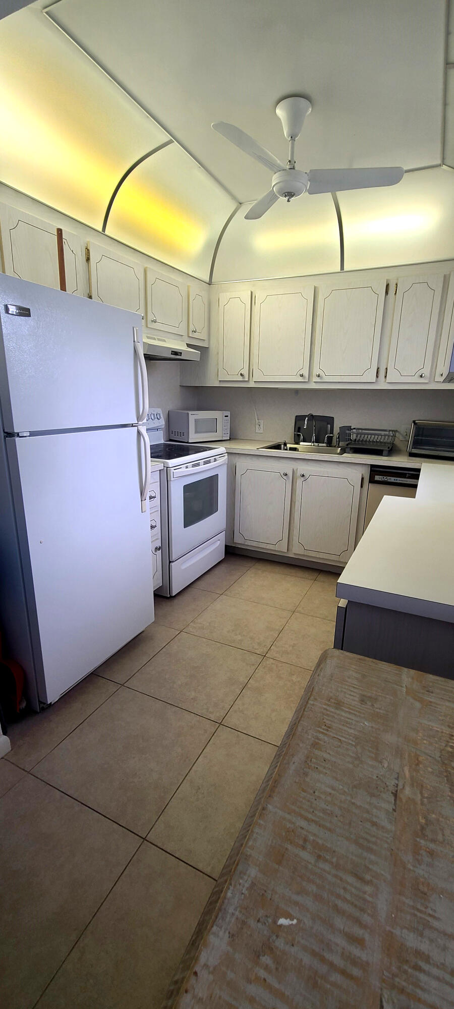270 Suffolk F Boca Raton, FL 33434 - Photo 13 of 21 a kitchen with stainless steel appliances kitchen island granite countertop a sink and cabinets