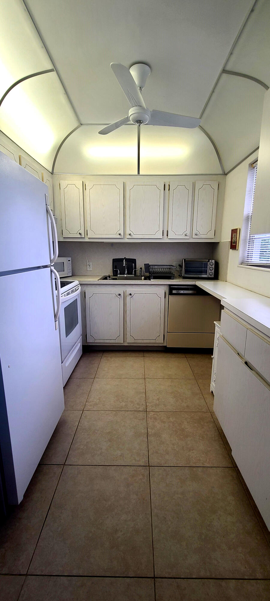 270 Suffolk F Boca Raton, FL 33434 - Photo 15 of 21 a kitchen with a sink and cabinets