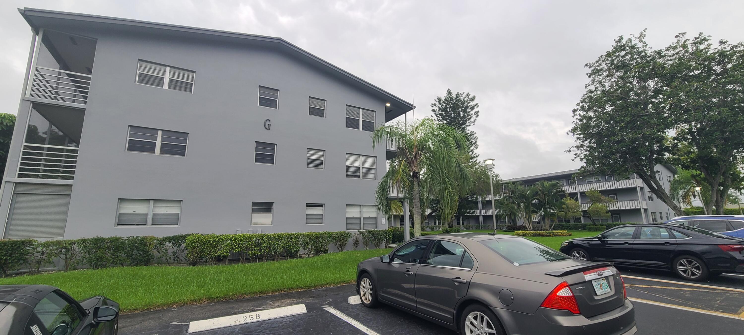 270 Suffolk F Boca Raton, FL 33434 - Photo 21 of 21 a view of a patio with couches and a fire pit and a yard