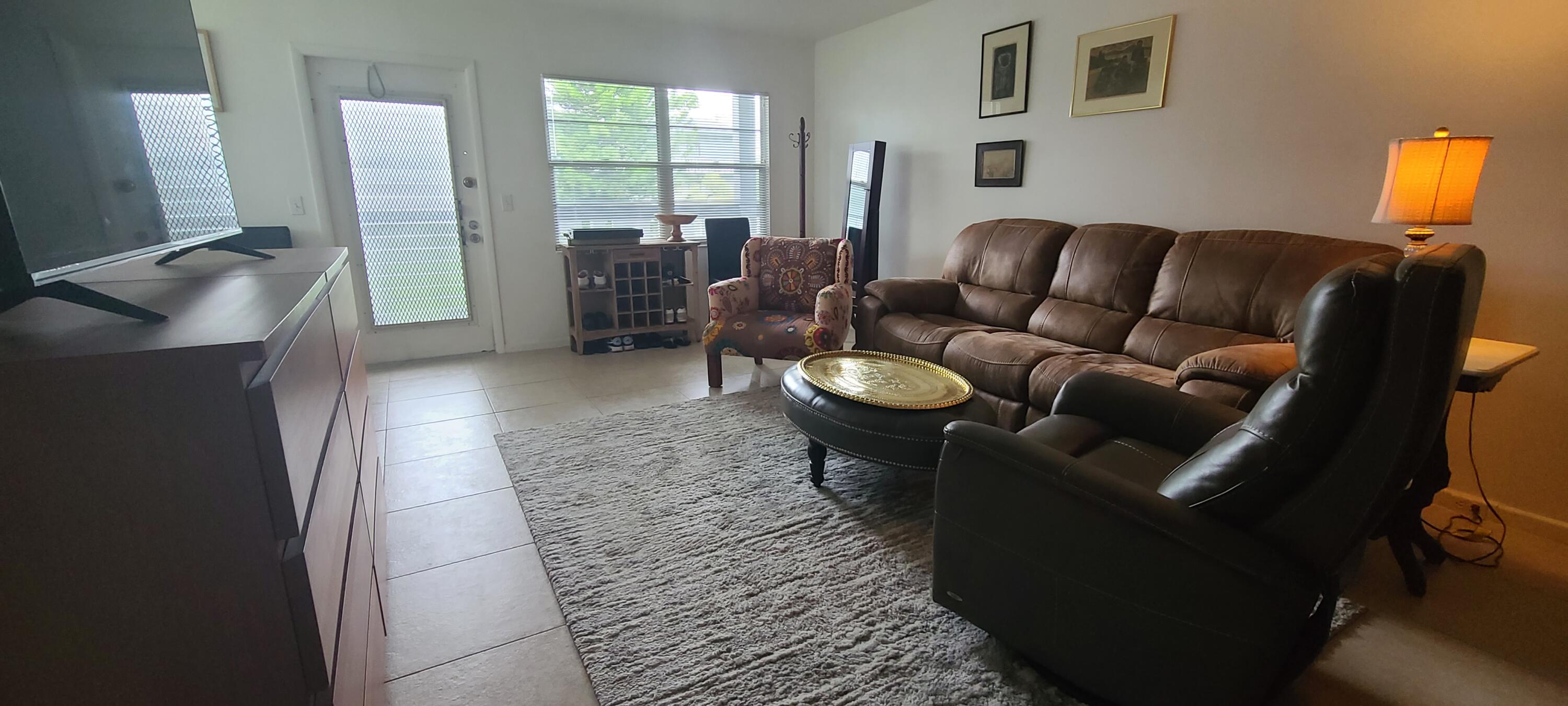 270 Suffolk F Boca Raton, FL 33434 - Photo 3 of 21 a living room with furniture and a flat screen tv