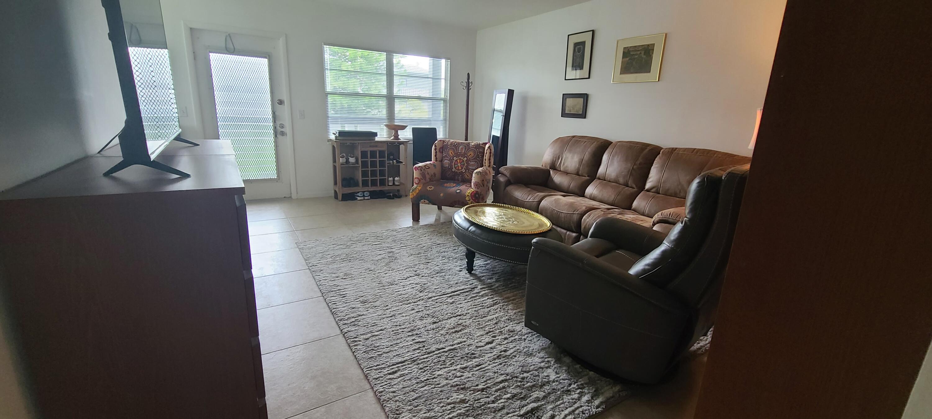 270 Suffolk F Boca Raton, FL 33434 - Photo 4 of 21 a living room with furniture and a fireplace