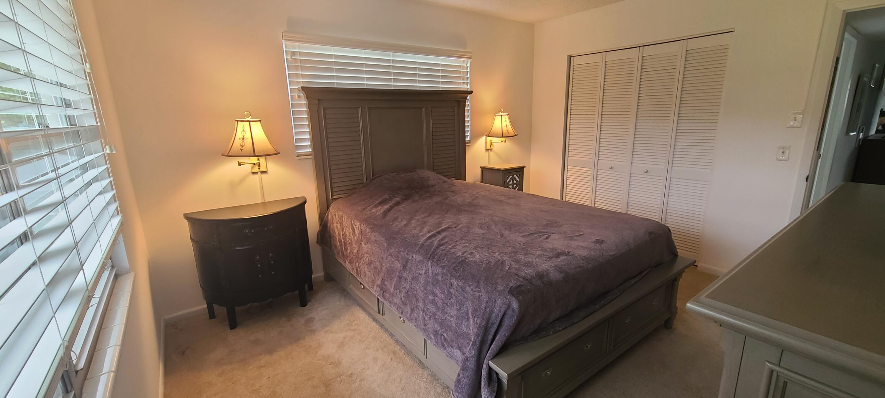 270 Suffolk F Boca Raton, FL 33434 - Photo 7 of 21 a bedroom with a bed and a mirror on the dresser