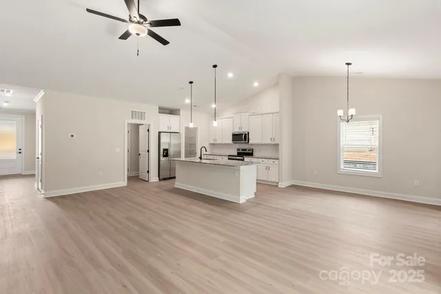 a view of kitchen with refrigerator and window