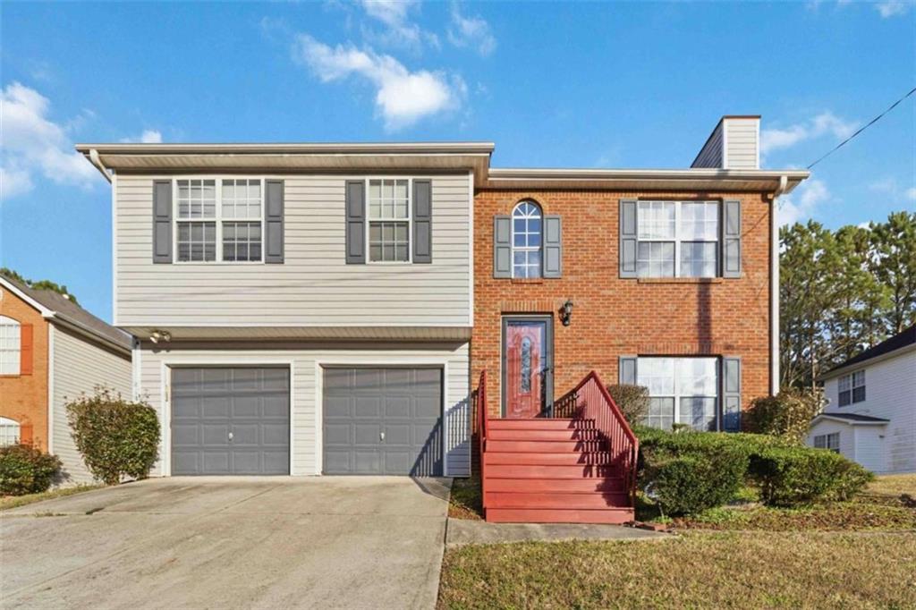 a view of a house with wooden fence