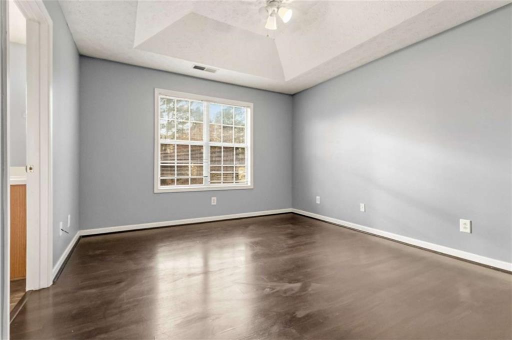 4170 Jewel Terrace Conley, GA 30288 - Photo 16 of 29 an empty room with wooden floor and windows