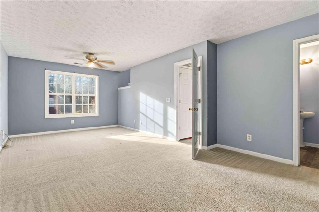 4170 Jewel Terrace Conley, GA 30288 - Photo 19 of 29 an empty room with windows and cabinet