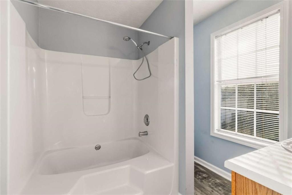 4170 Jewel Terrace Conley, GA 30288 - Photo 20 of 29 a bathroom with a shower and a tub