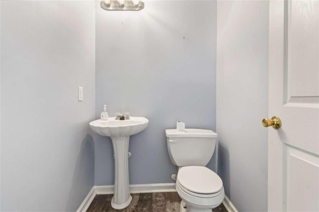 4170 Jewel Terrace Conley, GA 30288 - Photo 22 of 29 a bathroom with a toilet sink and mirror