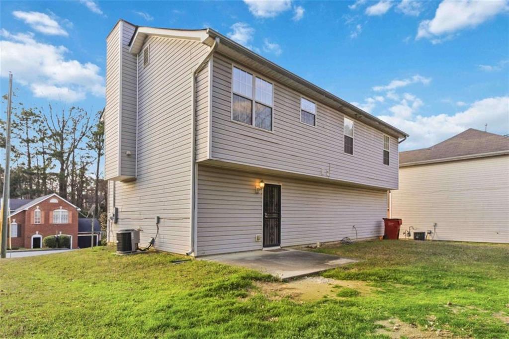 4170 Jewel Terrace Conley, GA 30288 - Photo 25 of 29 a backyard of a house with table and chairs