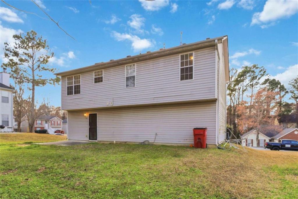 4170 Jewel Terrace Conley, GA 30288 - Photo 27 of 29 a front view of a house with a garden