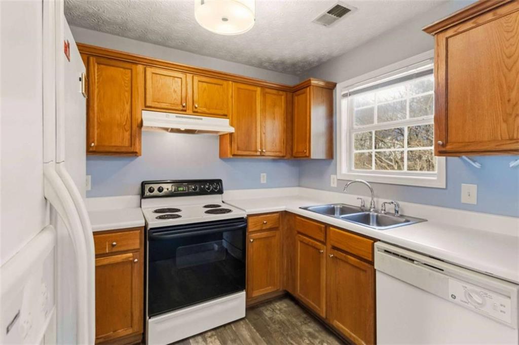 4170 Jewel Terrace Conley, GA 30288 - Photo 10 of 29 a kitchen with a sink stove top oven and cabinets