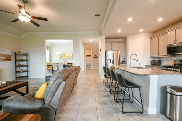 a backyard of a house with table and chairs
