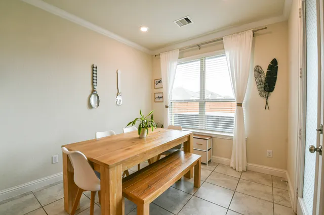 a dining room with furniture and a chandelier