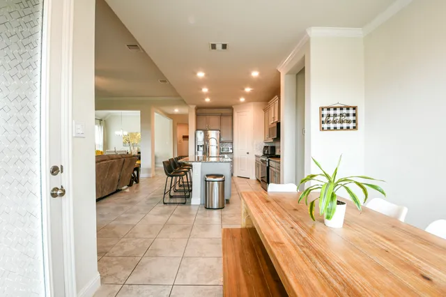a kitchen with stainless steel appliances granite countertop a stove a sink a microwave a refrigerator and cabinets