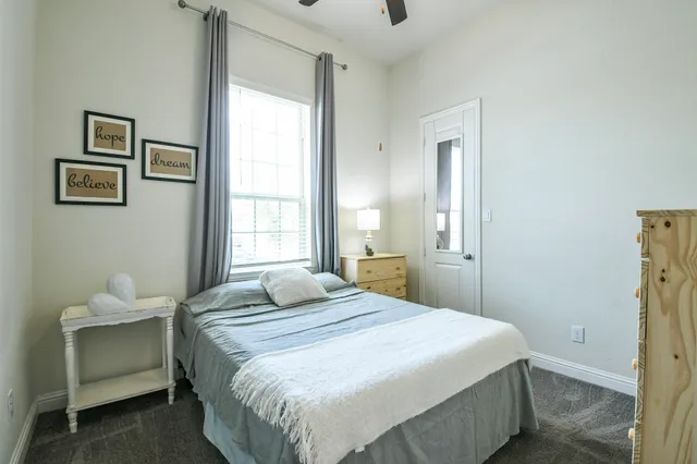 a bathroom with a double vanity sink a mirror and a bathtub