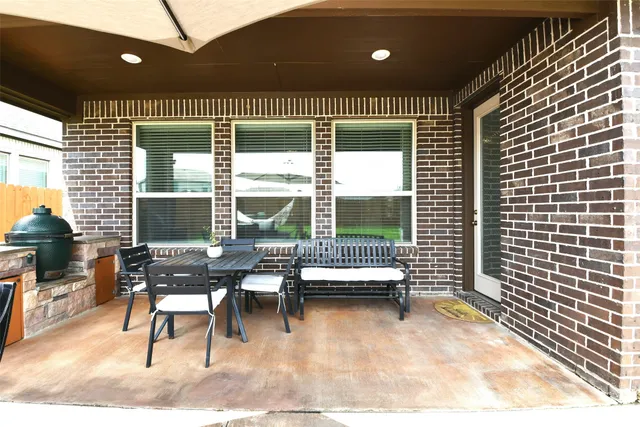 a view of a patio with a table and chairs