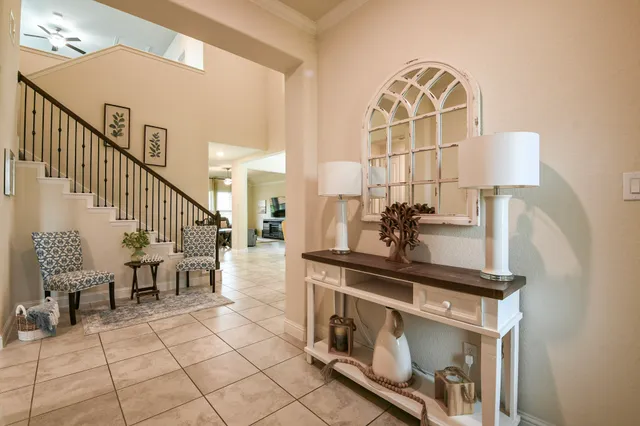 a view of hall way with furniture and a chandelier