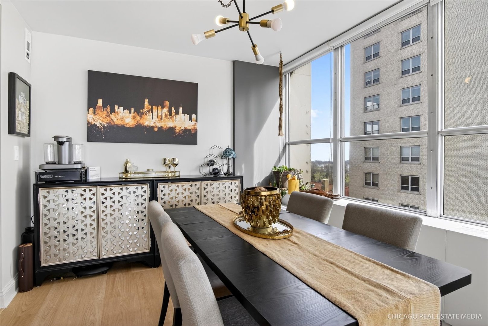 655 West Irving Park Road, Unit 1101 Chicago, IL 60613 - Photo 11 of 26 a view of a dining room with furniture wooden floor and chandelier
